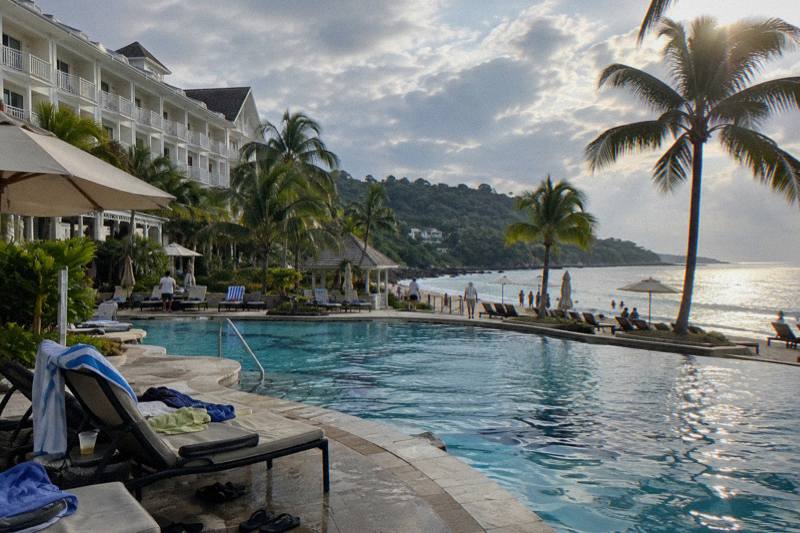 Beachfront resort hotel with a pool at sunset