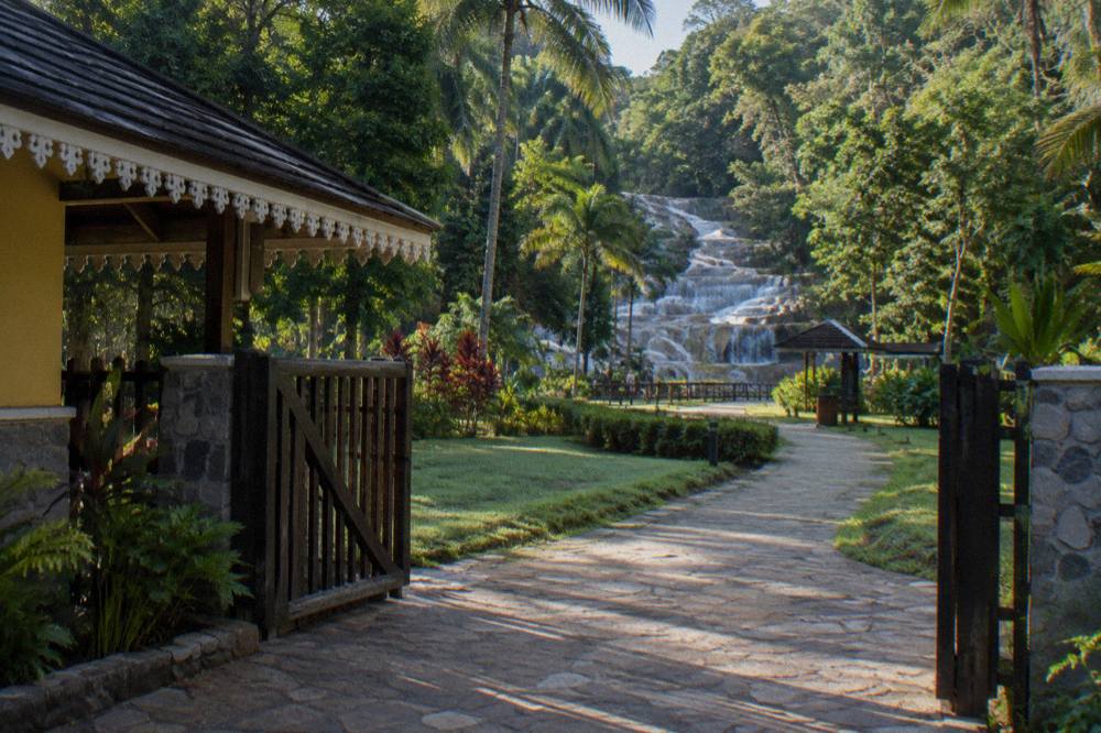 Entrance gate and walkway to Dunn's River Falls park in morning light